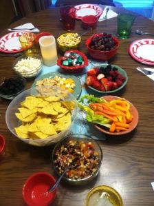 Tam adds colorful snacks to the table. That table holds many stories and laughter.